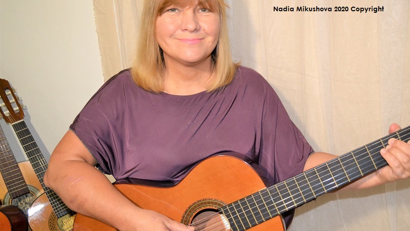 woman playing guitar.Nadia Mikushova 2020 Copyright